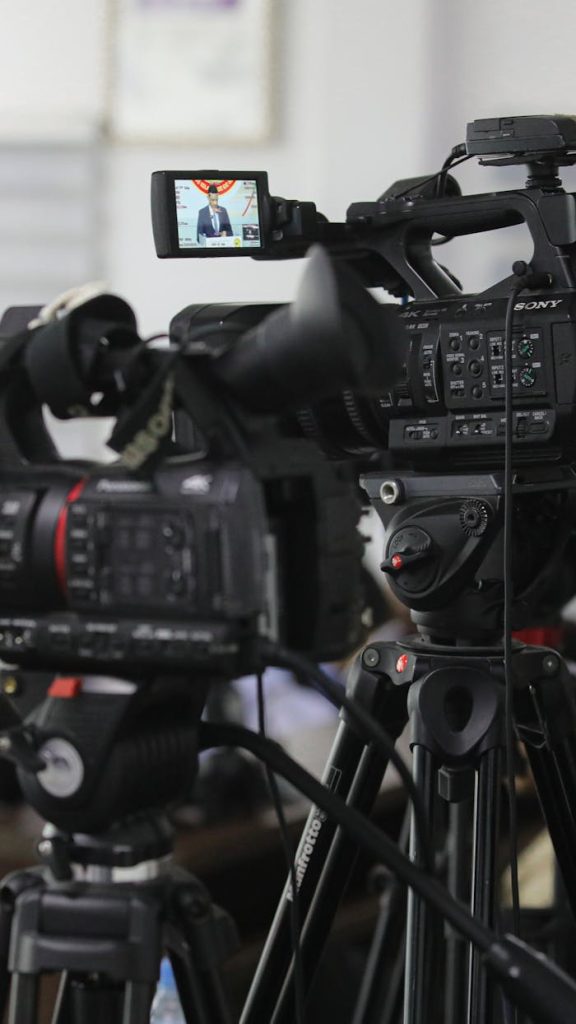 Close-up of professional video cameras set for filming indoors.